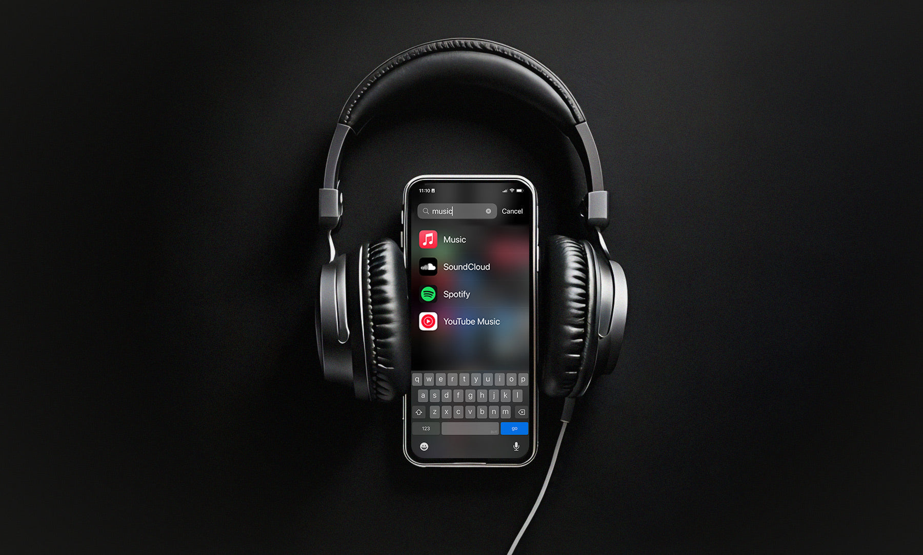 Heaphones on a phone showing apps for music streaming services. 