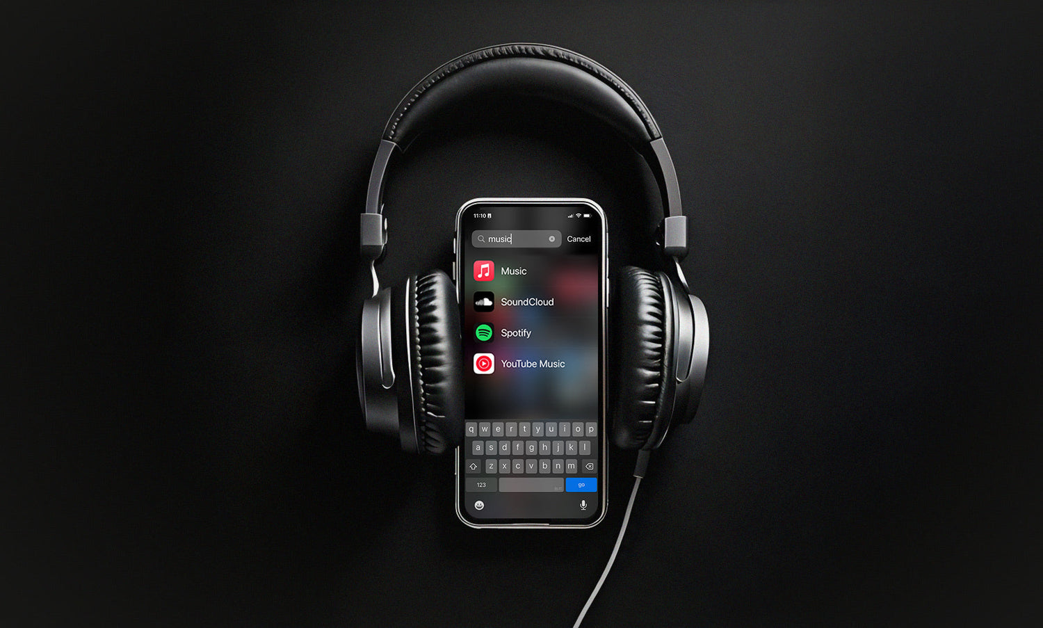 Heaphones on a phone showing apps for music streaming services. 